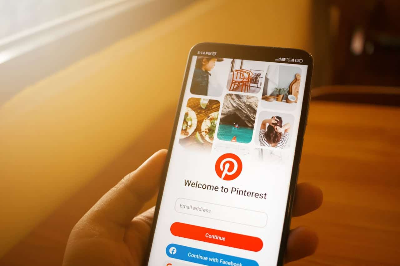Man using mobile phone to search how to use pinterest for blogging