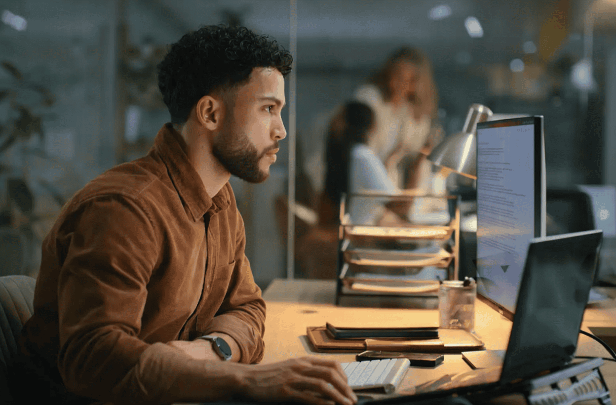 Businessman at computer searching for CRO Keyword Cannibalization Errors