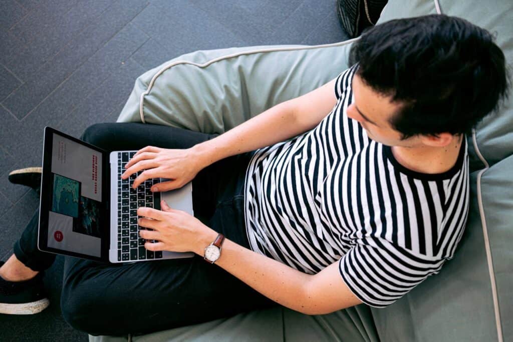 Influencer typing on a laptop